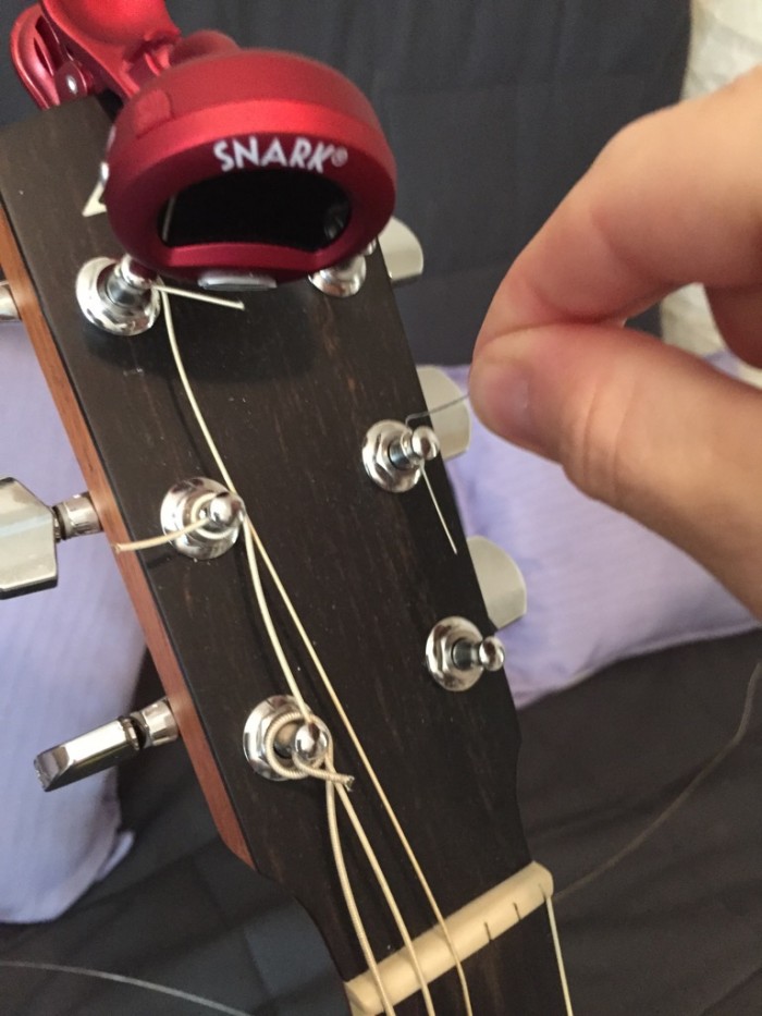 stringing a guitar - tuning hardware