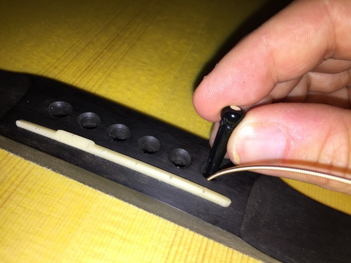 stringing a guitar - peg insert